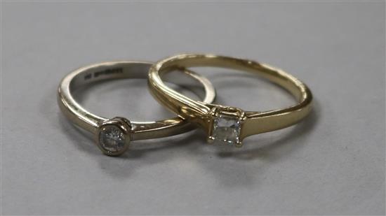An 18ct white gold and solitaire diamond ring and a 9ct gold and princess cut solitaire diamond ring.